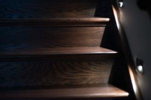 Detail of Oak Stairs in a dark stain shown with custom lighting